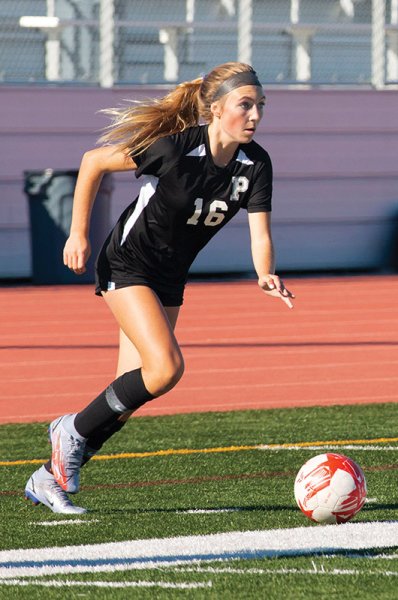 girl playing soccer