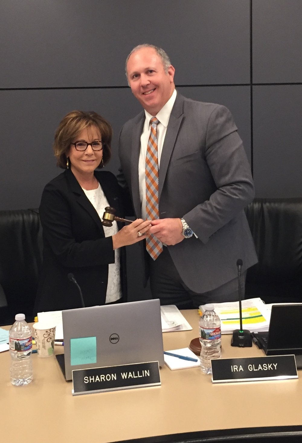 Sharon Wallin and Ira Glasky pass the gavel