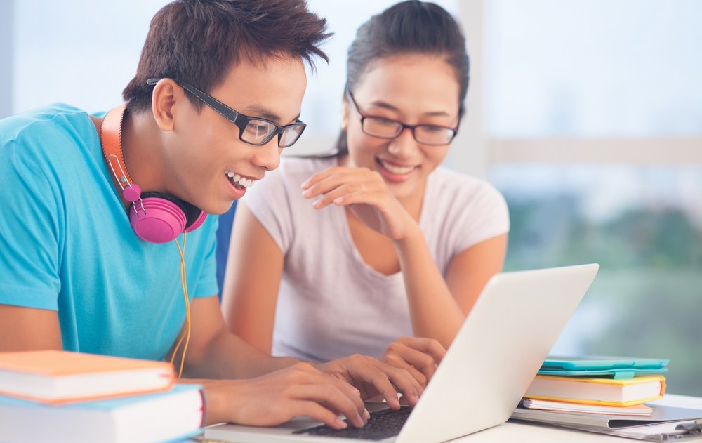 Two students looking at a laptop