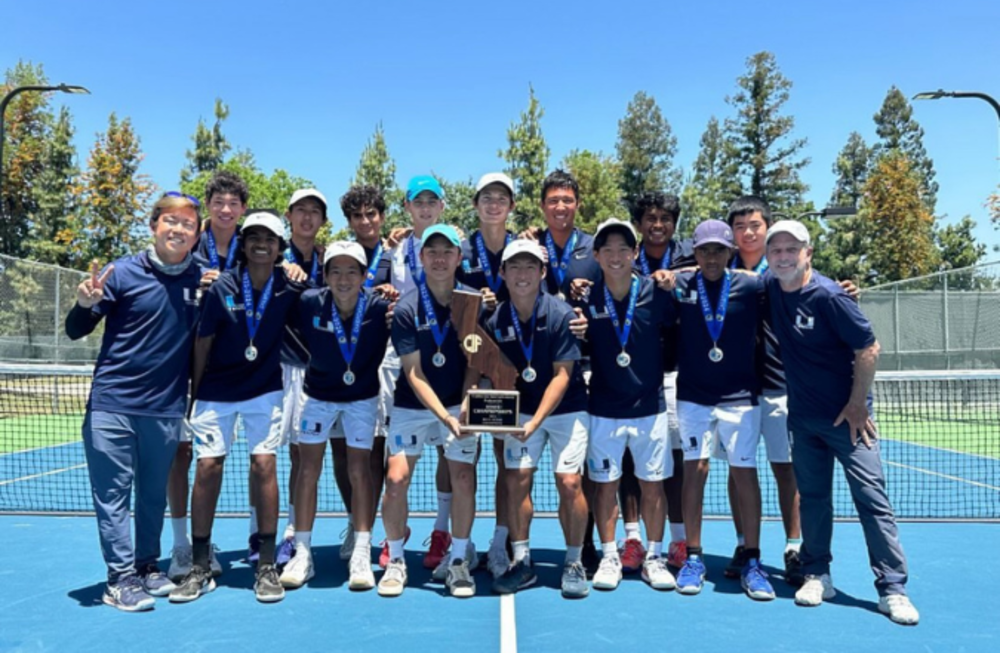 Uni boys tennis team holding state trophy 