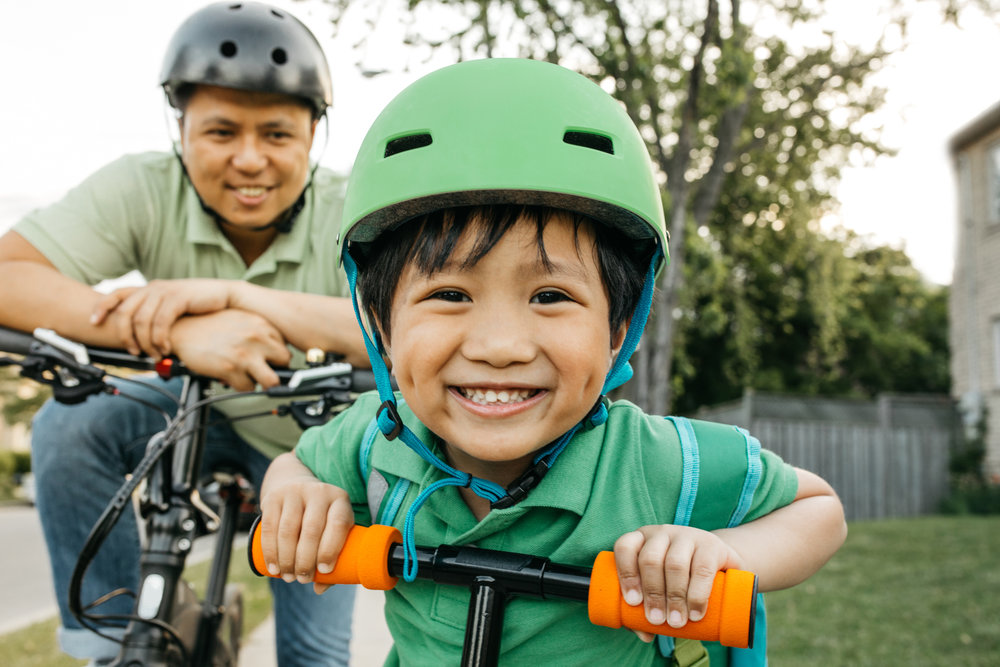 Boy with father helmet safety