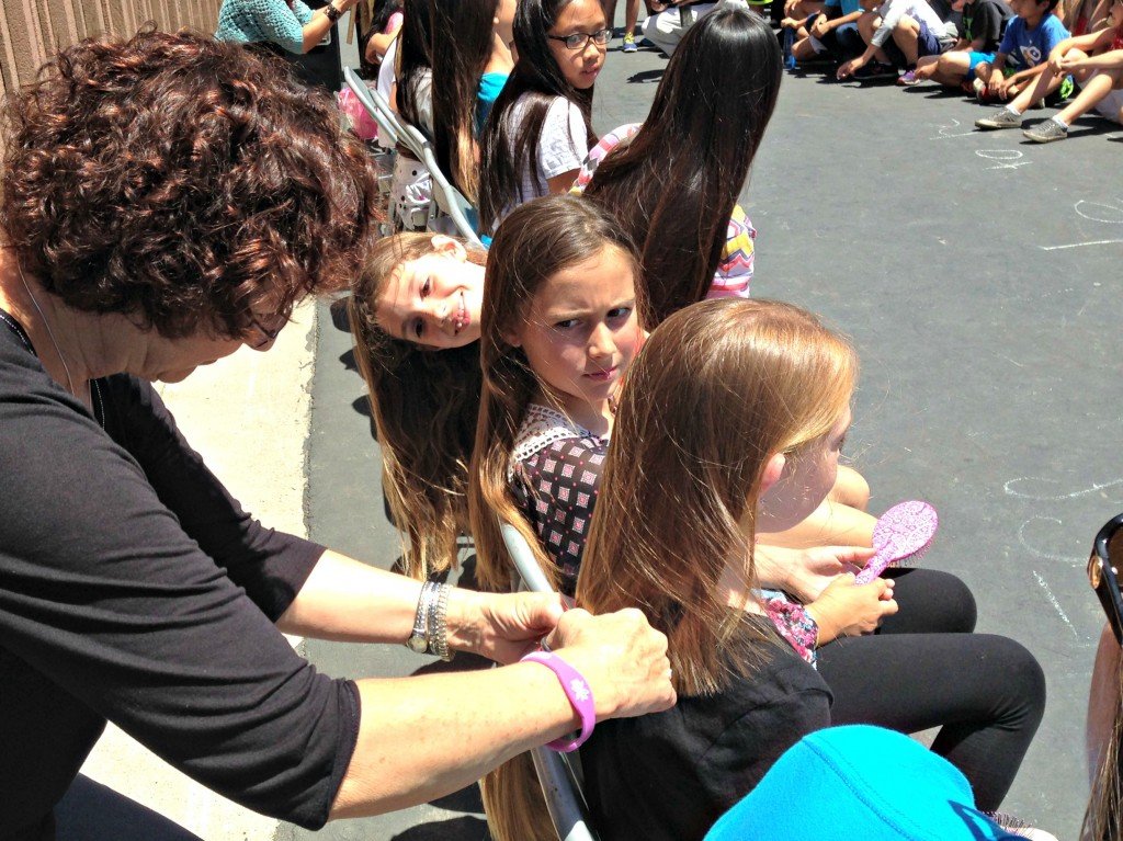 Audrey Coburn gets a haircut as her friend look on